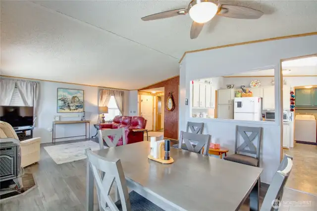 View showing open layout of dining/ living and view to kitchen.