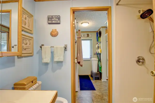 Looking from the guest bath to the laundry. To the right is the custom/large walk-in shower.