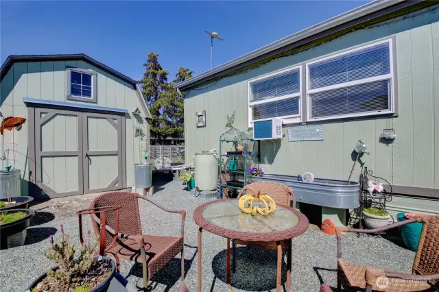 Large patio area with storage shed. Patio set stays.
