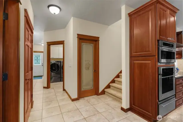The 2nd door to the laundry, the pantry, and the bonus rm stairs are accessed off the back hall next to the garage interior door.