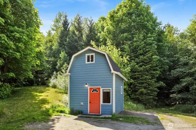 The tiny house in the back yard has a kitchen, living area, loft and bathroom with a shower and incinerating toilet.