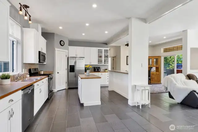 Looking left from the front door to the beautifully remodeled kitchen with stainless steel appliances.