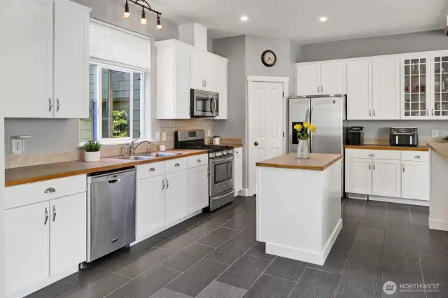 There is a large walk-in pantry in the corner of the kitchen.