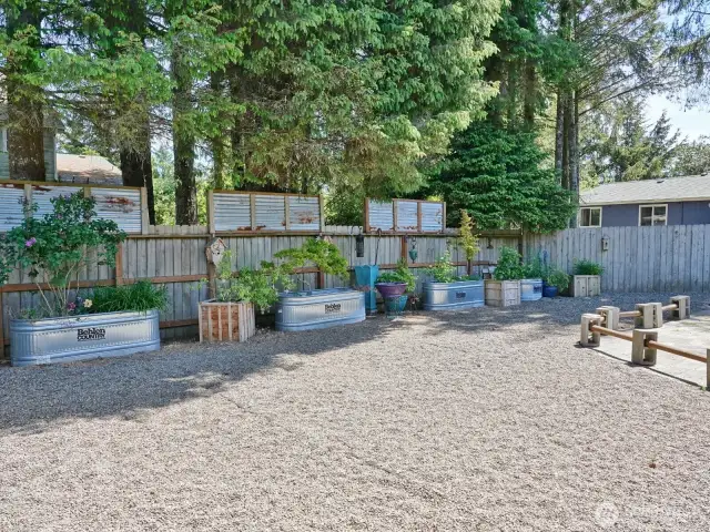 Spacious Backyard ~ fenced with raised flower beds.