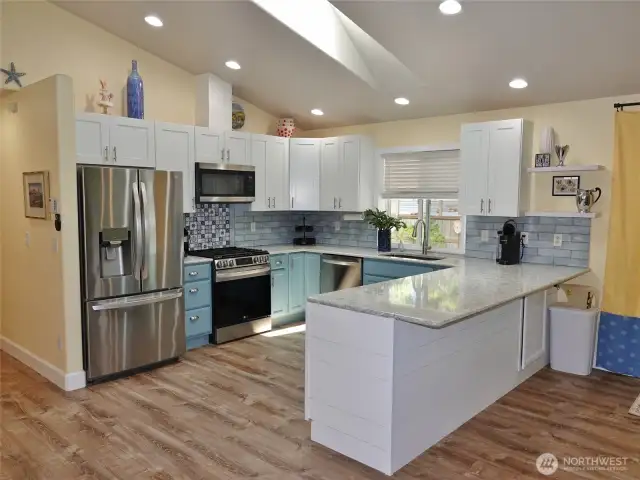Kitchen w/ slab granite counters.