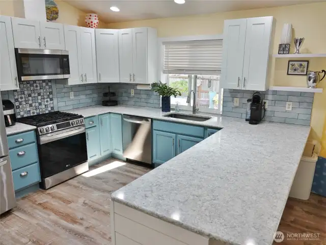Kitchen w/ eating bar and newer upper cabinets.