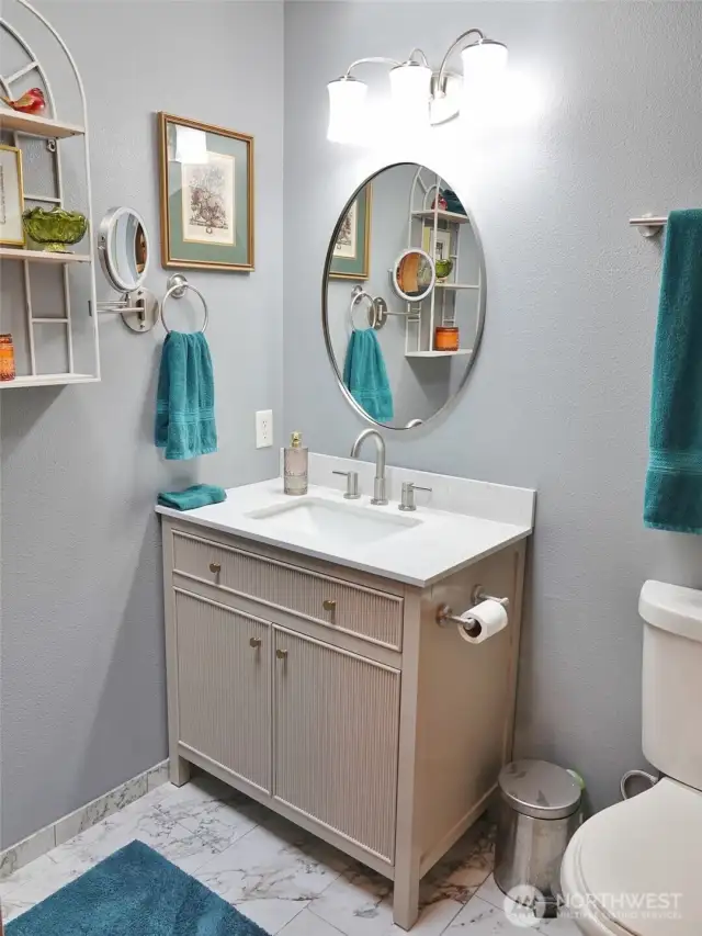 Beautifully remodeled Guest Bathroom w/ tile floors and vanity. There is a skylight too.