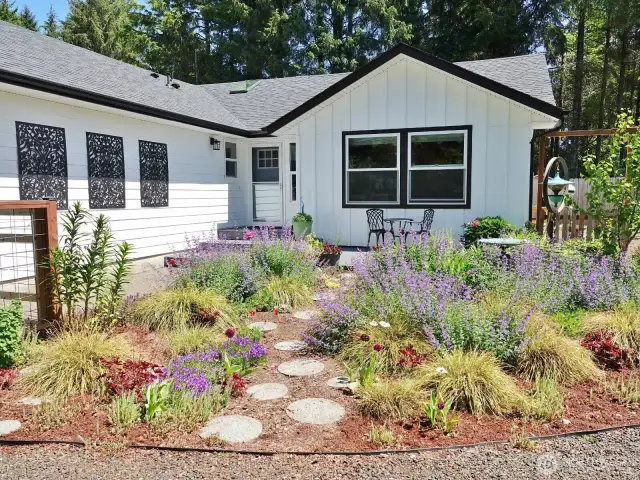Beautiful flowers, shrubs and trees with paver stones.