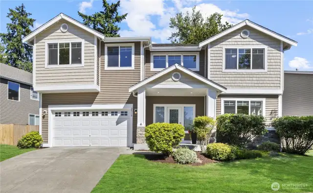 Charming Puyallup home with 2-car garage and inviting front porch in a peaceful community