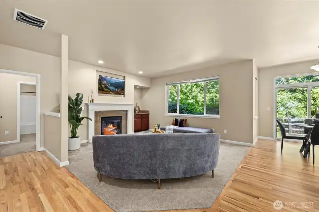Cozy second living room with gas fireplace and greenbelt views – Puyallup, WA    This inviting second living room in Puyallup’s LaGrande Station community offers a perfect blend of comfort and tranquility. A large picture window frames lush greenbelt views, filling the space with natural light and a peaceful ambiance. The cozy gas fireplace with tile surround and elegant white mantle adds warmth and charm, while the built-in cabinet nook offers display or storage space. Whether you're relaxing after a long day or entertaining guests, this living room delivers serene comfort in one of Puyallup, WA’s most desirable neighborhoods.