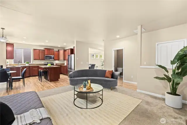 This spacious open-concept layout in Puyallup’s LaGrande Station community seamlessly connects the kitchen, casual dining area, and secondary living room—perfect for everyday living and entertaining. The kitchen features rich wood cabinetry, granite countertops, stainless steel appliances, and a central island with bar seating. Adjacent to the kitchen is a bright breakfast nook with views of the greenbelt, and just steps away, a half bath provides main-floor convenience. With its functional flow, hardwood floors, and stylish design, this space offers comfort and connection in one of Puyallup, WA’s most desirable neighborhoods.