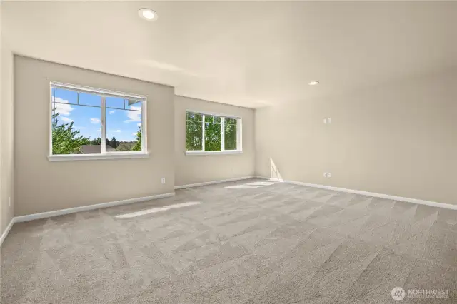 Spacious upstairs loft with dual exposure and views toward Washington State Fairgrounds – Puyallup, WA    This versatile bonus loft in Puyallup’s LaGrande Station is the perfect flex space for a home theater, rec room, office, or playroom. Natural light fills the room through two large windows—one facing Chateau Dr and the other offering serene greenbelt views. The clean design, plush carpet, and recessed lighting enhance the bright, open feel, while its elevated position provides distant views toward the Washington State Fairgrounds. A standout feature for any home in this desirable Puyallup neighborhood.