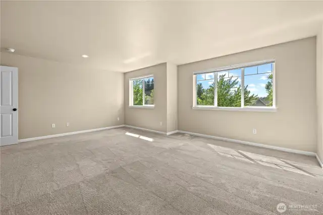 Sunlit loft or media room with flexible layout and tree-lined views – Puyallup, WA    This large upper-level loft or bonus room in Puyallup’s LaGrande Station community offers bright, flexible living space perfect for a home theater, gym, office, or playroom. With multiple windows facing Chateau Dr and tree-lined surroundings, you’ll enjoy plenty of natural light and a sense of openness. The neutral tones, clean carpet lines, and spacious layout create a blank canvas ready to fit your lifestyle in one of Puyallup, WA’s most well-connected neighborhoods—just minutes from freeway access and the Washington State Fairgrounds.