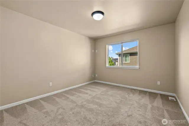 Comfortable upstairs bedroom with neighborhood view – Puyallup, WA    Located on the upper level of this beautifully maintained home in LaGrande Station, Puyallup, WA, this bedroom offers a bright and peaceful retreat. A large window frames views of the surrounding neighborhood while allowing in plenty of natural light. Fresh carpet, neutral wall tones, and a clean layout provide the perfect canvas for a guest room, kids’ bedroom, or private home office. Enjoy a quiet, residential feel with easy access to nearby parks, schools, and Sounder Train connections.