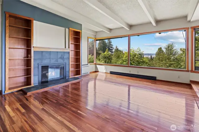 Living room with gleaming, gorgeous hardwoods.  Wood fireplace as well.