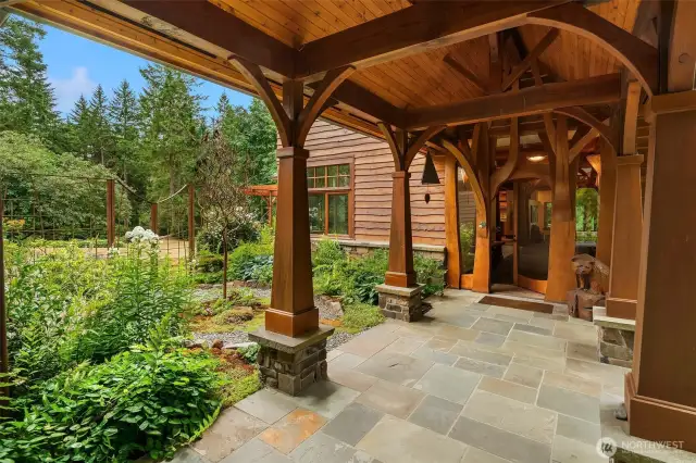 Custom front entry door design borrows from the surrounding trees