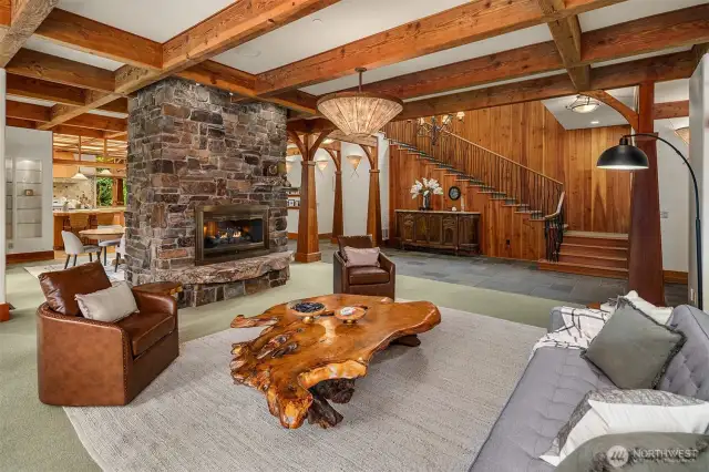 The double-sided stone fireplace beautifully separates the open spaces and adds warmth to each area