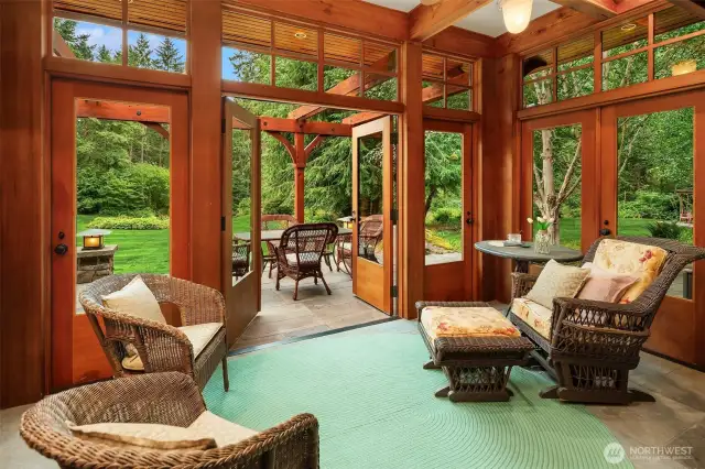 Cozy sunroom opens to the dining room through sliding glass doors as well as opening to the exterior stone terrace.