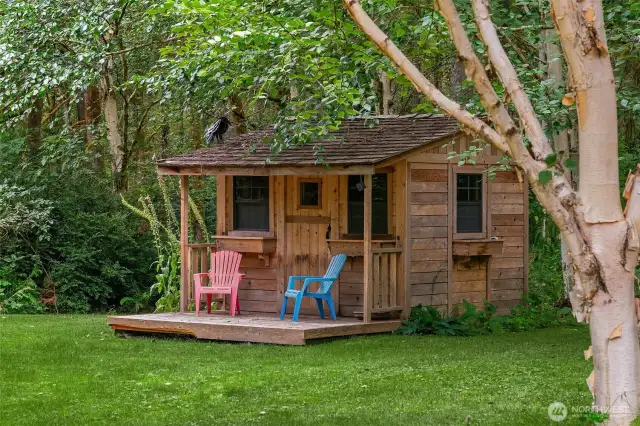 Small charming playhouse on back lawn area