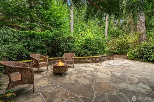 A hidden private shaded stone patio off the kitchen area