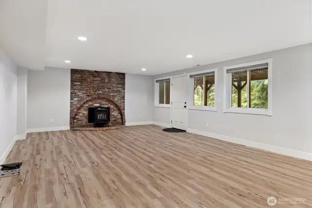 Daylight basement is plumbed for a 2nd kitchen and has a woodstove with a woodburning insert