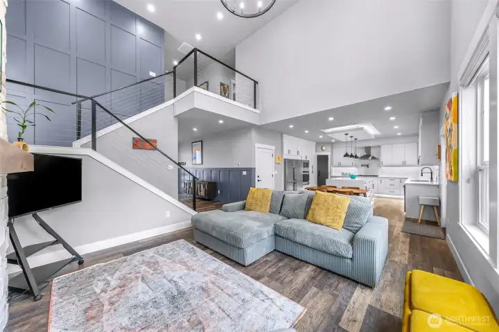 Open living space connected to dining area and large kitchen.