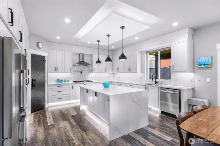 Beautiful countertops with a waterfall edge and lots of customized lighting.