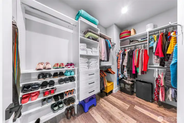 Large walk in closet with custom built-ins