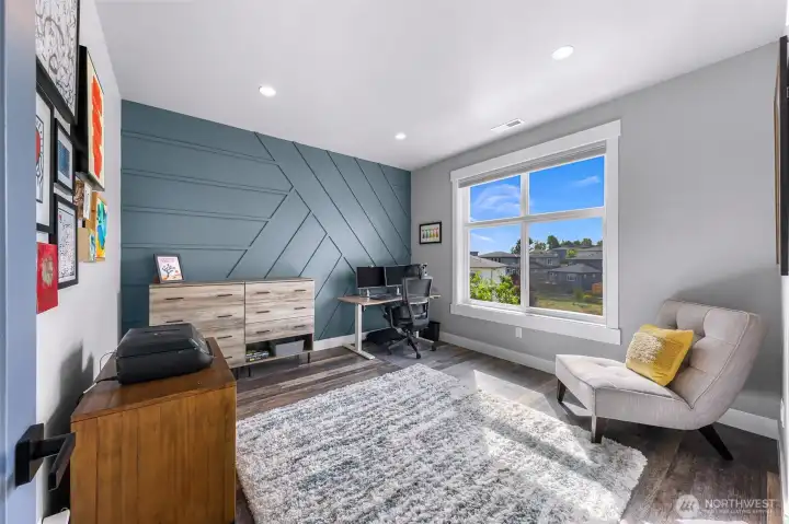 Second upstairs bedroom with accent wall and occasional mountain views from the south facing window.