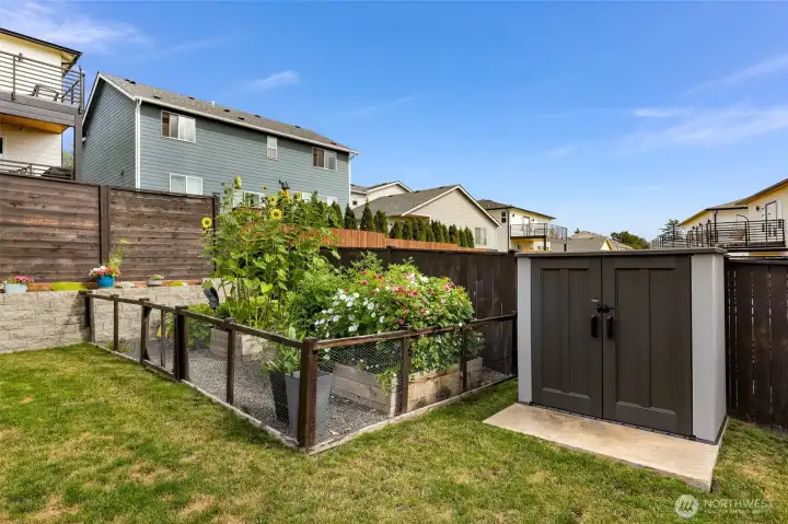 Fenced garden area and easy access tool shed.
