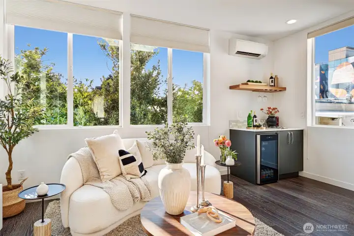Walls of windows bring in a lot of natural light, and a beverage fridge for entertaining.