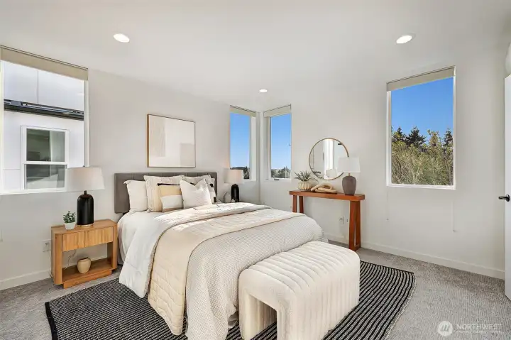 Spacious primary bedroom on the third level.