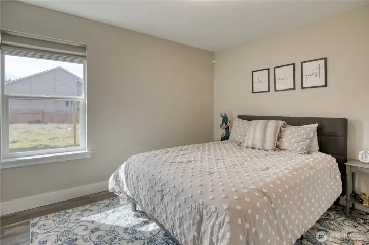 On the other side of the house are the 2nd and 3rd bedrooms and full guest bath.