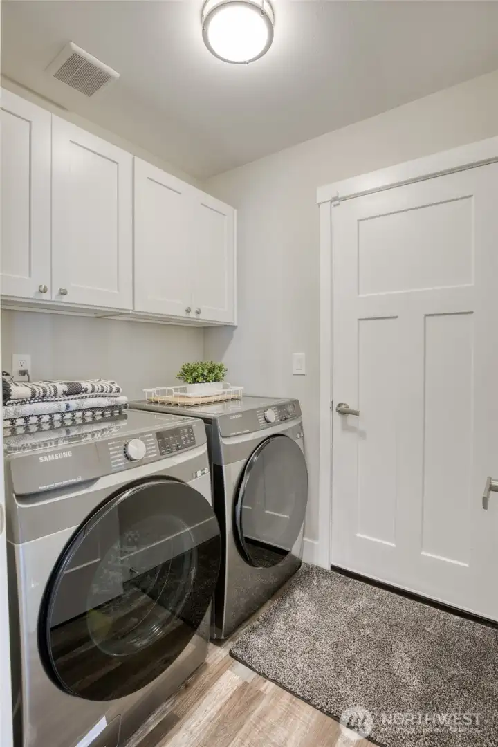 Utility room with cabinet storage and door to garage.
