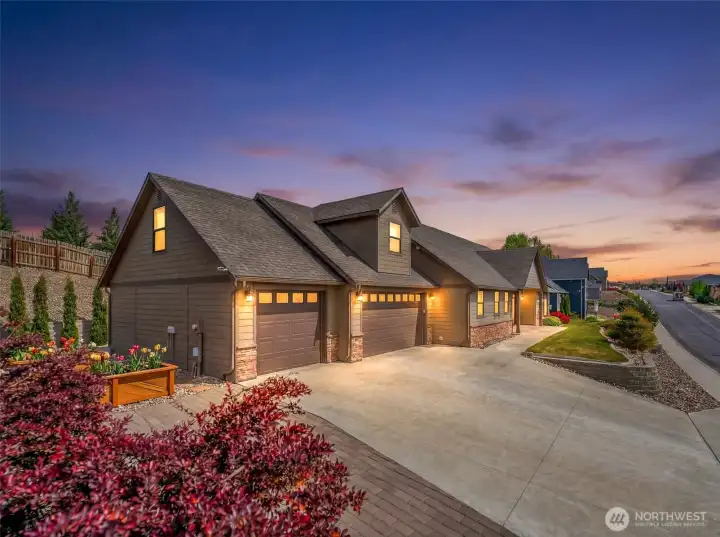 Striking Highlander Golf Course home with exceptional curb appeal, featuring a spacious 3-car garage, expansive driveway, and beautifully maintained landscaping