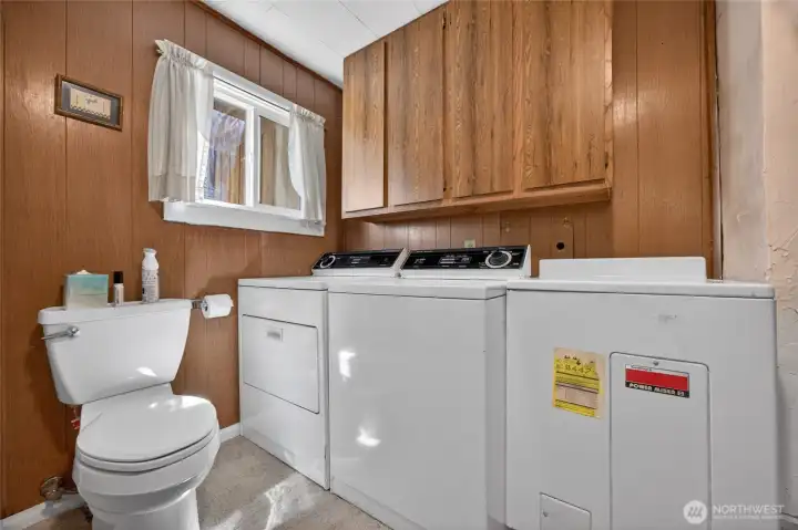 Bathroom with laundry appliances installed.