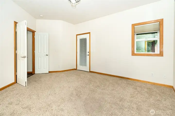 Primary suite with exterior door to private covered deck. Perfect place to start your day with a quiet cup of coffee or end your day relaxing with a cocktail or glass of wine while enjoying the outdoors. Primary suite with exterior door to private covered deck. Perfect place to start your day with a quiet cup of coffee or end your day relaxing with a cocktail or glass of wine while enjoying the outdoors.