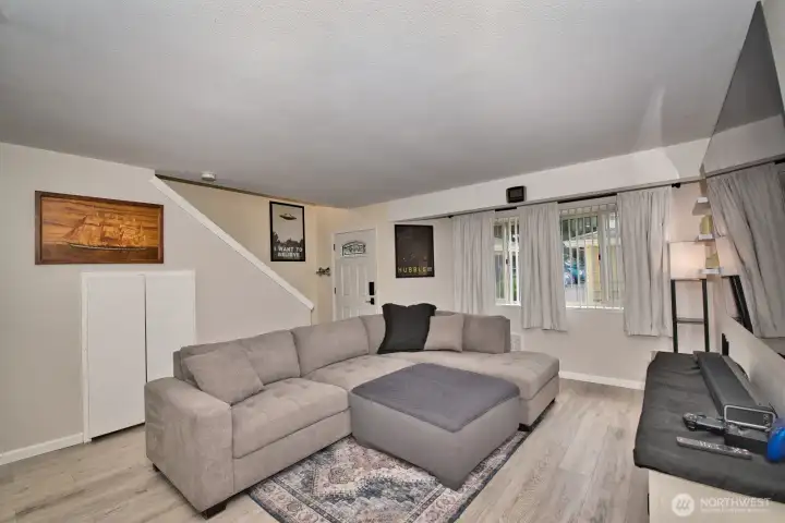 Spacious living room with updated laminate hardwood floors.