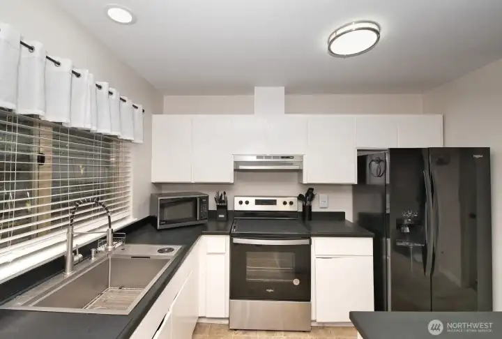 Plenty of counterspace and cabinets in this roomy kitchen.