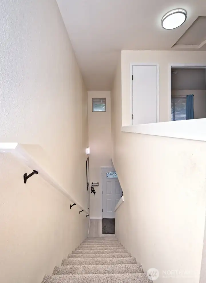 Looking down to entry -- new carpet on stairs.