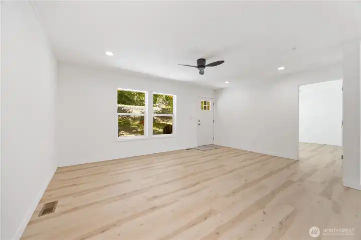 The expansive living room opens into the dining and kitchen area.