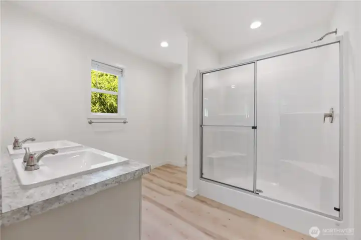 The main bath is part of the main suite with a walk in shower.