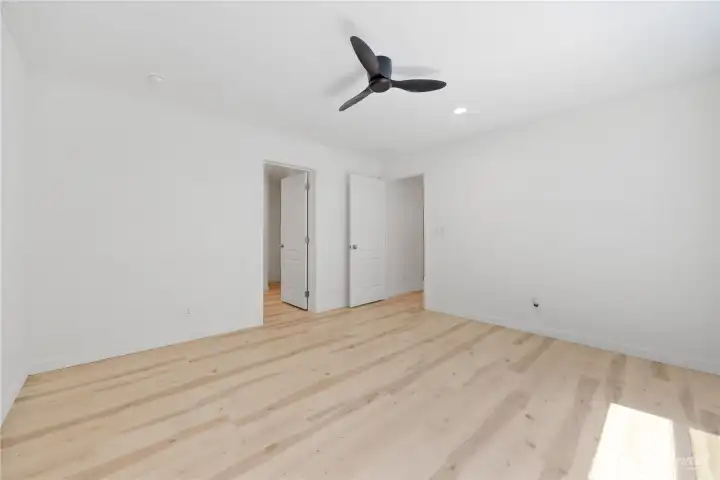 The main suite with walk in closet and adjacent bath.