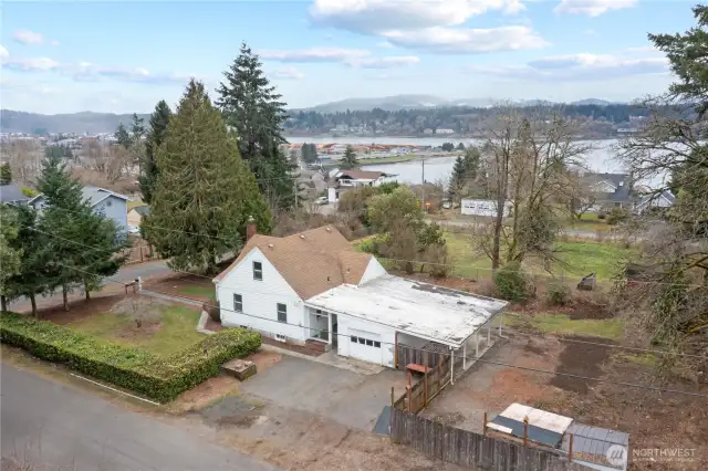 Looking west. vacant chain linked fenced field is part of the home's tax parcel. There are nice views from the second story of the water, the west side and the black hills. Possible other views with tree trimming/removal?