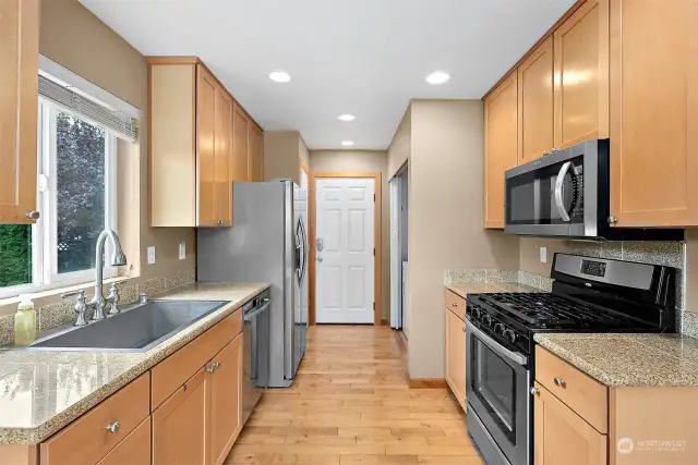 Entire kitchen with back door to garage!