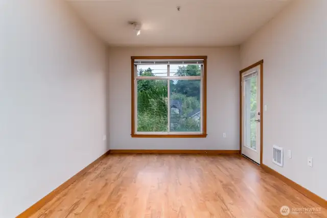 Living room with large window and door to balcony
