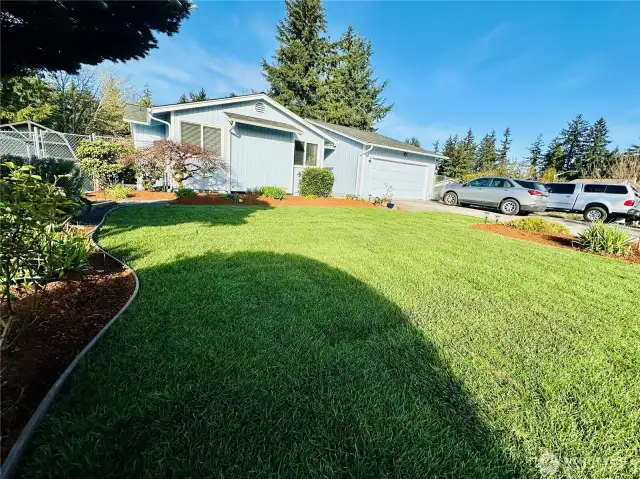 Front of home with yard, driveway has off-street parking for 5+