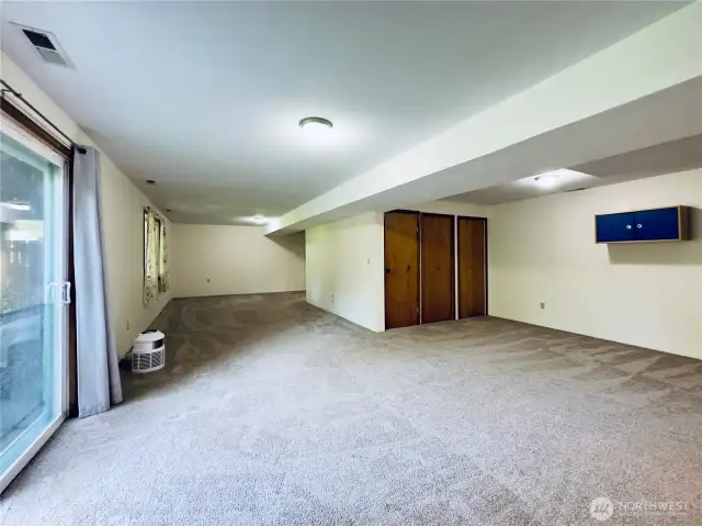 Daylight basement great room looking towards the stairs, loads of storage