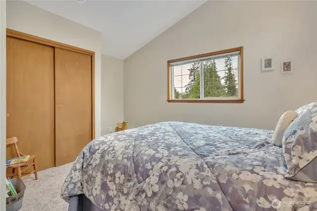 Upstairs bedroom with vaulted ceiling.