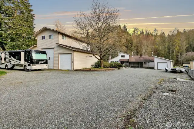 Expansive shop, with unfinished upper apartment, sits on the front part of the property. Off street parking for everyone!
